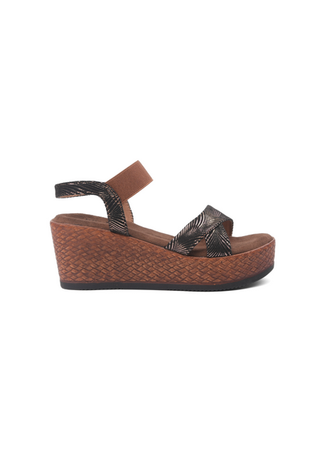 Brown wedge sandal with woven design on a white background