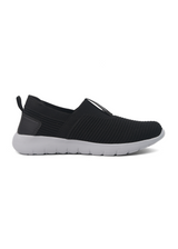 Black slip-on sneaker with white sole on a white background
